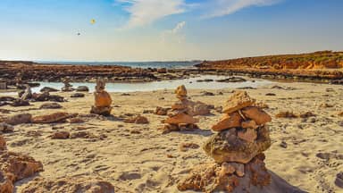 beach stones sand sea sky clouds  